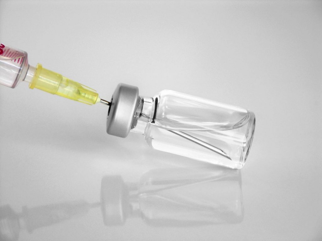 bottle of insulin being added to siringe